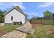 Well-maintained side yard with a rock drainage feature and a small wooden bridge, adding charm at 629 Houndsditch Cir, Wake Forest, NC 27587