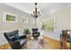 Bright sitting area with hardwood floors, a patterned rug, comfortable chairs, and ample natural light at 629 Houndsditch Cir, Wake Forest, NC 27587