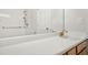 Bright bathroom featuring a single sink vanity with wood cabinets, a shower, and a large mirror at 6539 Clarksdale Ln, Durham, NC 27713