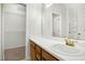 Bright bathroom with a walk-in closet, single sink, and a vanity with wooden drawers and doors at 6539 Clarksdale Ln, Durham, NC 27713