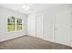 Bedroom featuring neutral carpet, closet, and window at 6539 Clarksdale Ln, Durham, NC 27713