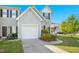 Charming townhouse with a well-maintained lawn, driveway, and mature trees at 6539 Clarksdale Ln, Durham, NC 27713