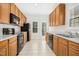 Efficient kitchen with ample cabinet space, black appliances, and tile flooring at 6539 Clarksdale Ln, Durham, NC 27713