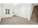 Living room featuring neutral walls, plush carpet, and natural light at 6539 Clarksdale Ln, Durham, NC 27713