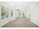 Bright living room featuring neutral paint, plush carpet, and natural light at 6539 Clarksdale Ln, Durham, NC 27713