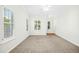 Living room featuring neutral walls, plush carpet, and ample natural light at 6539 Clarksdale Ln, Durham, NC 27713