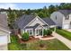 Home with a fenced yard, mature landscaping, and an attached garage at 7028 Pebble Brook Way, Rocky Mount, NC 27804