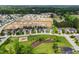 Community aerial view featuring a pond, playground, and new home construction at 7028 Pebble Brook Way, Rocky Mount, NC 27804