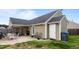 Cozy backyard patio featuring outdoor seating, grill, and a private entrance to the home at 7028 Pebble Brook Way, Rocky Mount, NC 27804