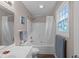 Well-lit bathroom features a shower with curtain and a vanity with a white countertop at 7028 Pebble Brook Way, Rocky Mount, NC 27804