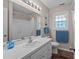 Bathroom featuring a mirror, blue towels, and a tub with shower at 7028 Pebble Brook Way, Rocky Mount, NC 27804
