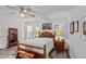 Bright bedroom features wood floors, a ceiling fan, and a traditional wood frame bed at 7028 Pebble Brook Way, Rocky Mount, NC 27804