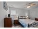 Bedroom features wood floors, a ceiling fan, and a traditional iron frame bed at 7028 Pebble Brook Way, Rocky Mount, NC 27804