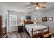 Bedroom features wood floors, a ceiling fan, and a traditional wood frame bed at 7028 Pebble Brook Way, Rocky Mount, NC 27804