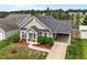 Aerial view of a well-maintained home with green lawn and mature trees at 7028 Pebble Brook Way, Rocky Mount, NC 27804