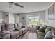 Cozy living room with a large window, comfortable seating, and neutral decor at 7028 Pebble Brook Way, Rocky Mount, NC 27804
