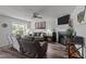 Bright living room featuring a fireplace, ceiling fan, and hardwood flooring at 7028 Pebble Brook Way, Rocky Mount, NC 27804