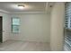 Neutral bedroom with white walls and floors, and a large window at 7412 Barberry Ct, Raleigh, NC 27615