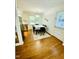 Dining room featuring wood floors, dining table set, white walls, and a door to the outside at 7412 Barberry Ct, Raleigh, NC 27615
