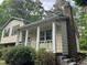 Charming home featuring a brick chimney, covered porch, and inviting curb appeal at 7412 Barberry Ct, Raleigh, NC 27615