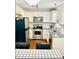 Bright kitchen featuring stainless steel appliances, white cabinetry, granite countertops, and subway tile backsplash at 7412 Barberry Ct, Raleigh, NC 27615