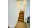 Wooden staircase leads up to a bright, inviting entryway with a white front door at 7412 Barberry Ct, Raleigh, NC 27615