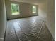 A bright bedroom with natural light streaming through two windows, highlighting the spacious layout at 788 Old Station Pointe, Angier, NC 27501