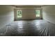 A spacious bedroom featuring ample natural light from two large windows, offering a bright and airy feel at 788 Old Station Pointe, Angier, NC 27501
