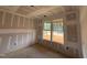 Unfinished bedroom featuring natural light from double hung windows during the construction phase at 788 Old Station Pointe, Angier, NC 27501