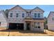 New construction two-story home with attached garage, covered porch and traditional design elements at 788 Old Station Pointe, Angier, NC 27501