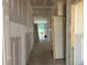 Unfinished hallway featuring white walls, and doors throughout the home during the construction phase at 788 Old Station Pointe, Angier, NC 27501