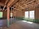 Unfinished interior showcasing the framing, windows, and layout of the new construction home at 788 Old Station Pointe, Angier, NC 27501