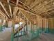 Unfinished interior featuring the stairway framing, exposed beams and open-concept design at 788 Old Station Pointe, Angier, NC 27501