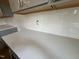 A close-up of a kitchen counter, showcasing a white countertop and subway tile backsplash at 788 Old Station Pointe, Angier, NC 27501