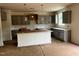 An incomplete kitchen featuring grey cabinets, a white subway tile backsplash, and an island with a white countertop at 788 Old Station Pointe, Angier, NC 27501