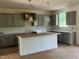Newly installed kitchen with sleek gray cabinets, subway tile, and an island at 788 Old Station Pointe, Angier, NC 27501