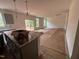 Open-concept living room with modern light fixture and sliding doors to the backyard at 788 Old Station Pointe, Angier, NC 27501