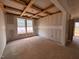 Unfinished living room with coffered ceilings and natural light from double hung windows during construction phase at 788 Old Station Pointe, Angier, NC 27501