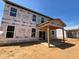 New construction homes under construction featuring a covered patio, ample windows, and yard space at 788 Old Station Pointe, Angier, NC 27501