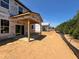 Rear view of new homes under construction with covered patios and ample outdoor space at 788 Old Station Pointe, Angier, NC 27501