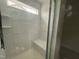 A modern shower with marble-style tile, a built-in seat, and a sleek glass enclosure for a luxurious bathing experience at 788 Old Station Pointe, Angier, NC 27501