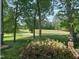 Lovely backyard with golf course views and flowering bushes at 8 Greenside Ct, Durham, NC 27707