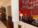 Stylish bar area with red accent wall, glass shelves, and sink at 8 Greenside Ct, Durham, NC 27707