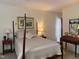 Traditional bedroom featuring a four-poster bed, neutral color palette, and elegant decor at 8 Greenside Ct, Durham, NC 27707