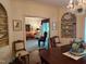 Elegant dining room with hardwood floors, built-in shelving, and a crystal chandelier at 8 Greenside Ct, Durham, NC 27707