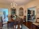 Formal dining room boasts beautiful hardwood floors, a chandelier, and adjacent living spaces at 8 Greenside Ct, Durham, NC 27707