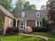 Beautiful brick home with dormer windows, white trim, and lush landscaping at 8 Greenside Ct, Durham, NC 27707