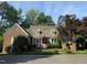 Quaint brick home featuring a cozy front porch and manicured landscaping at 8 Greenside Ct, Durham, NC 27707