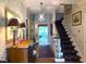Inviting foyer with hardwood floors, elegant chandelier, stairway, and views into the living spaces at 8 Greenside Ct, Durham, NC 27707