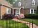 Inviting brick home with a landscaped walkway leading to the front door at 8 Greenside Ct, Durham, NC 27707